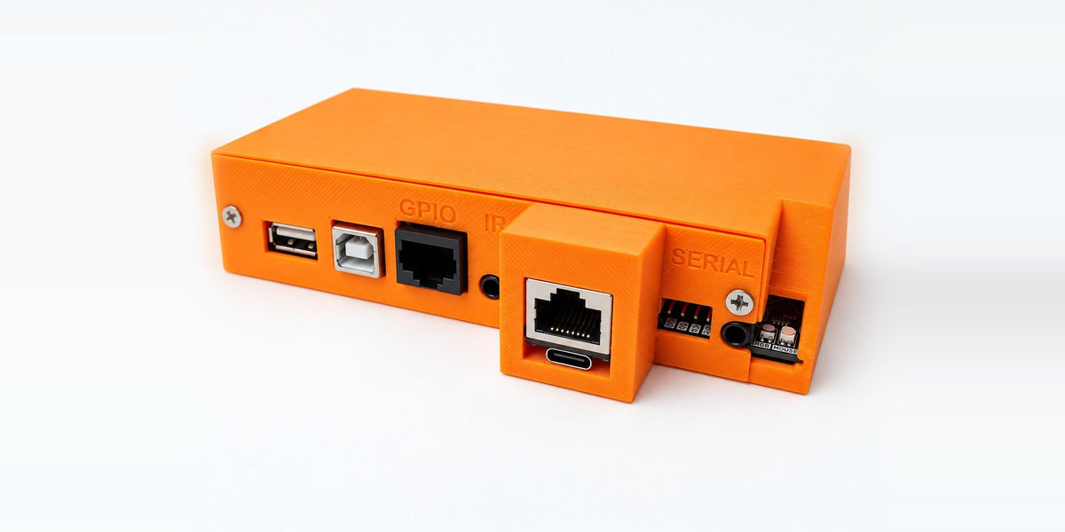 The custom IO bridge for BrightSign: an orange enclosure with USB, GPIO, IR, Ethernet, USB-C, and serial ports on the front