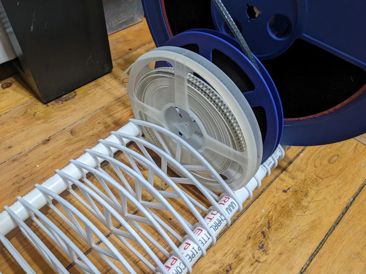 3D-printed SMT reel rack holding reels of electronic components